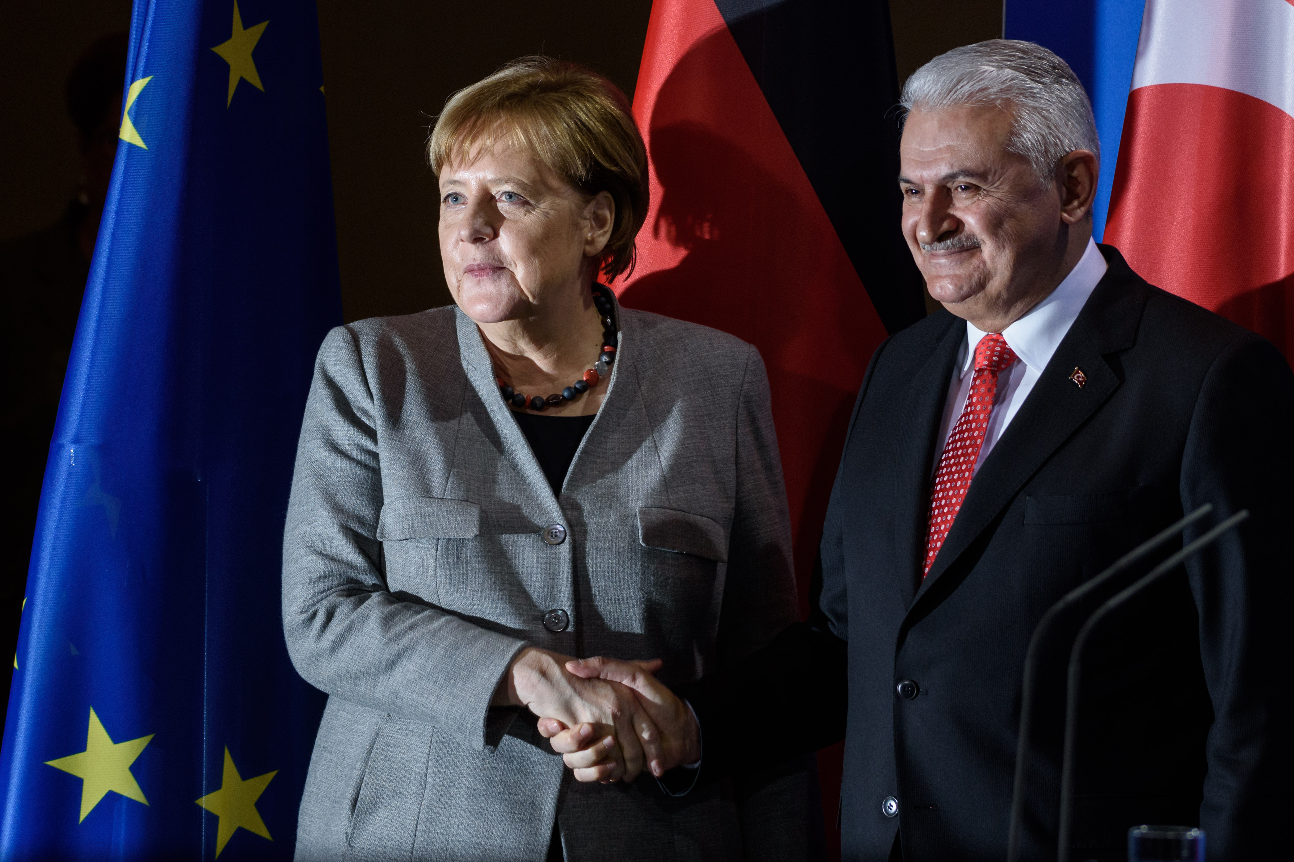 Merkel and Yildirim handshaking.